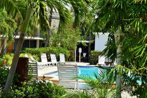 a group of chairs sitting next to a swimming pool at Dolphin Key Resort - Cape Coral in Cape Coral