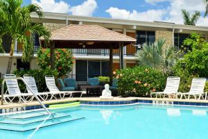 a swimming pool with chairs and a gazebo at Dolphin Key Resort - Cape Coral in Cape Coral