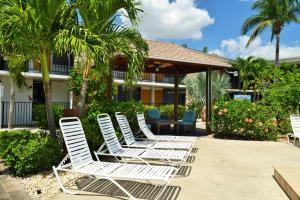 a row of white chairs sitting on a patio at Dolphin Key Resort - Cape Coral in Cape Coral