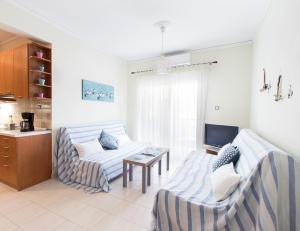 a living room with a couch and a table at Sweet home with spectacular sea view in Paleo Tsifliki