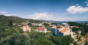 a town on a hill with houses and the ocean at Sweet home with spectacular sea view in Paleo Tsifliki