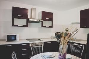 a kitchen with a table with a vase on it at Apartma Trebušca in Dolenja Trebuša