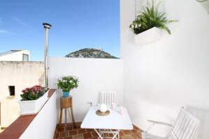 a balcony with a table and chairs and a view at Pollenca Townhouse in Pollença