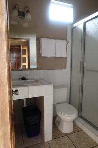 a bathroom with a toilet and a sink and a mirror at Hotel La Escalinata in Copan Ruinas