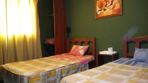 Letto o letti in una camera di Hostal Residencial Mochica