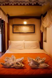 a bedroom with two towels on a bed at PATMOS Mathios Studios- apartments in Patmos +108 photos