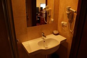 a bathroom with a white sink and a mirror at Pensjonat Solis Sarbinowo in Sarbinowo +8 photos