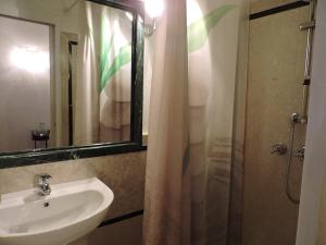 a bathroom with a sink and a shower with a mirror at Il Giardino Segreto in Tellaro +16 photos