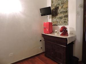 a red appliance sitting on a counter in a room at Il Giardino Segreto in Tellaro