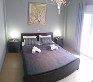 a bedroom with a bed with two stuffed animals on it at Grey House in Prinos
