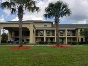 two palm trees in front of a building at Inn at Mulberry Grove in Port Wentworth