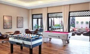 a living room with a pool table and ping pong ball at Four Seasons Resort Marrakech in Marrakesh