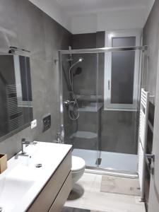 a bathroom with a shower and a toilet and a sink at Residenza sul Mare in Civitanova Marche