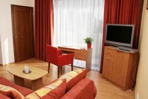 TV a/nebo společenská místnost v ubytování Hotel Maxim