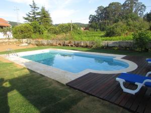 a swimming pool in a yard with a deck at Casa de ferias em Caminha - Minho - in Caminha