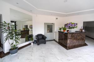 a lobby with a chair and a desk with plants at Апартаменты Пять Гнезд in Sochi