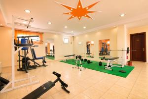 a gym with exercise equipment and a star on the ceiling at Hotel Diamond in Limenaria