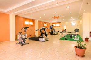 a gym with treadmills and exercise equipment in a room at Hotel Diamond in Limenaria