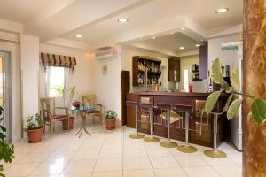 a bar in a living room with a counter at Hotel Diamond in Limenaria