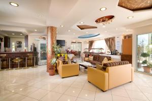 a living room with couches and a lobby at Hotel Diamond in Limenaria