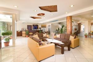 a lobby with couches and a table in a room at Hotel Diamond in Limenaria