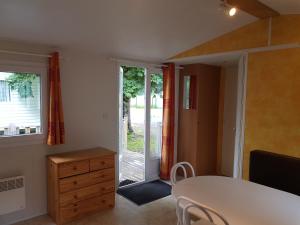 Zimmer mit einem Tisch und einer Glasschiebetür in der Unterkunft Les Berges Du Cele in Bagnac