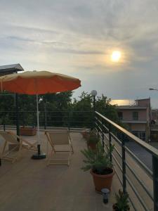 a patio with an umbrella and chairs on a balcony at Anna Georgiou in Skala Sotiros