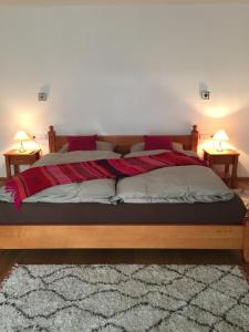 a bedroom with a large bed with two lamps at Haus Eibl in Seefeld in Tirol