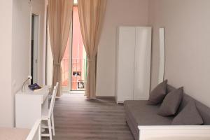 a living room with a couch and a large window at B&B Materdei 14 in Naples