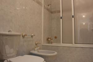 a bathroom with a toilet and a shower at Cozy Summer House by the Beach in Ovar +22 photos