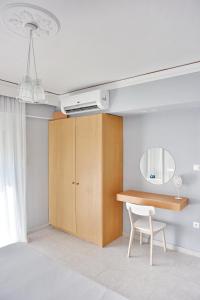 a room with a desk and a mirror and a chair at Alkyoni City Apartment in Rhodes Town