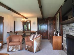 a living room with chairs and a fireplace at Rudow Roost in Beech Mountain