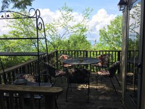 a patio with a table and chairs on a deck at Rudow Roost in Beech Mountain