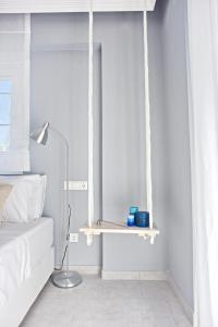 a bedroom with a hanging shelf and a bed at Alkyoni City Apartment in Rhodes Town