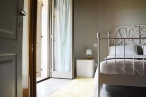 a bedroom with a bed next to a window at Nonno Gino suite in Monte San Savino
