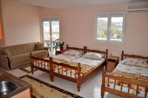a living room with two beds and a couch at Apartments Perezaj in Ulcinj