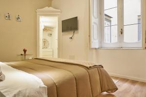 En eller flere senge i et værelse på Donna Mariella