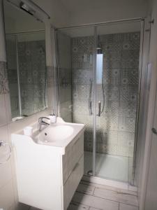 a bathroom with a sink and a shower at Casa Leo in Capoliveri