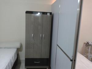 a bedroom with a cabinet next to a bed at Lacqua DiROMA V in Caldas Novas