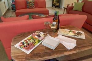 a table with two plates of food and a bottle of wine at The Grey Owl Inn in Saint Simons Island +11 photos
