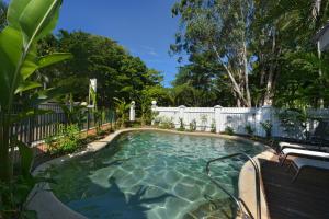 a swimming pool in a yard with a fence at Seascape Holidays - Tropic Sands in Port Douglas