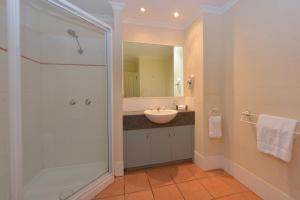 a bathroom with a sink and a shower at Seascape Holidays - Tropic Sands in Port Douglas