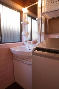 松山的住宿－道後宿度假屋，浴室配有白色水槽和水槽