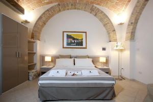 a bedroom with a large bed with an arched ceiling at Victoria Royal Apartments & Rooms in Termoli +47 photos