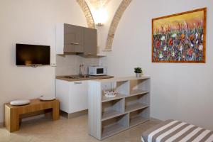 a kitchen with a sink and a counter top at Victoria Royal Apartments & Rooms in Termoli