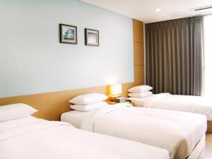 Postel nebo postele na pokoji v ubytování YOUUS Hotel