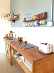 a kitchen with a wooden counter with a sink at Loft Alpaca in Iquique