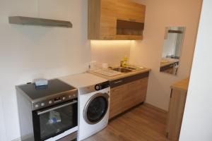 a kitchen with a washing machine and a sink at Kärdla Holiday House in Kärdla