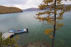 a boat is docked at a dock on a lake at Gobi - Zen in Ulaanbaatar