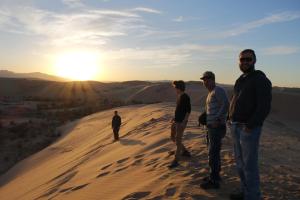 four men standing on top of a sand dune at Gobi - Zen in Ulaanbaatar +3 photos